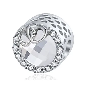 Vintage silver crown charm with large central crystal and heart-shaped honeycomb design