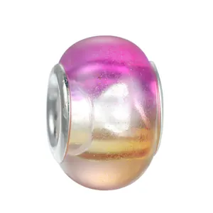 Detailed macro view of gradient pink to orange glitter glass charm with silver core