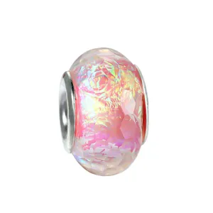 Macro view of Aurora pink faceted glass charm bead with silver metal core for DIY bracelets