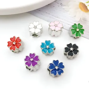 Detail of colorful enamel flower charms with crystals for DIY jewelry making