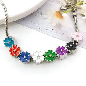 Silver snake chain bracelet with eight colorful enamel flower charms and sparkling zircons