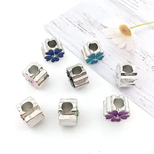Detail of colorful enamel flower beads with rhinestones and large holes for DIY bracelets