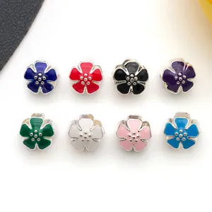 Macro detail of various colorful enamel flower charms for DIY jewelry making