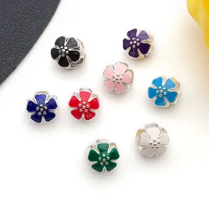 Macro shot of colorful floral enamel charm beads in eight colors for DIY jewelry making