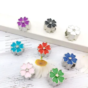 Detail of colorful enamel flower beads with crystal centers for DIY jewelry making