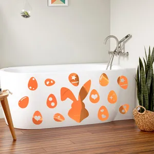 Detail of orange bunny and Easter egg stickers applied on a white bathtub surface