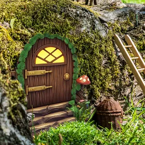 Miniature fairy garden door with wood texture, moss, and a tiny ladder decoration