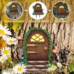 Detail of fairy garden door on tree trunk with glowing windows and floral accents