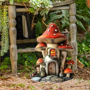 Detail of red fairy mushroom house garden ornament with glowing window in garden