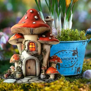 Close-up of a fairy mushroom house garden ornament with red spotted roof and mossy base