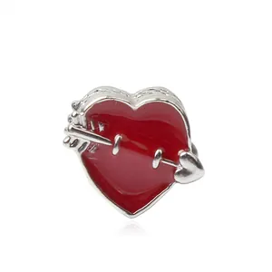 Detailed close-up of a red enamel heart charm with arrow design for DIY jewelry