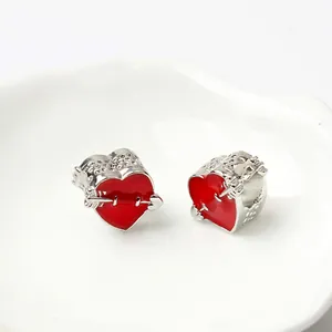 Close-up of heart charms with red enamel and arrow design for DIY jewelry bracelets