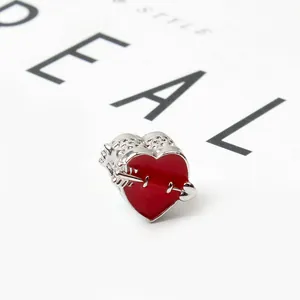 Cupid arrow heart charm with red enamel and hollow silver metal patterns