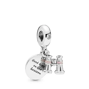 Detail of silver telescope charm and engraved round disc with pink enamel and zircon