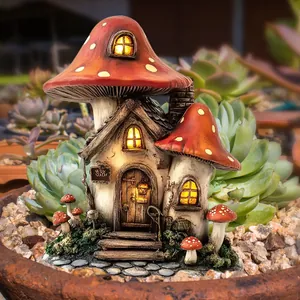Close-up of lighted mushroom fairy house with red roof for garden path decoration