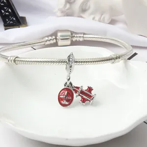 Silver snake chain bracelet featuring red enamel airplane and fire hydrant charms