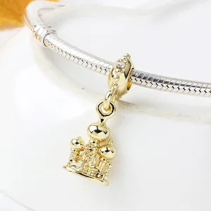 Macro shot of gold St. Basil's Cathedral charm with zircon detail on silver snake chain