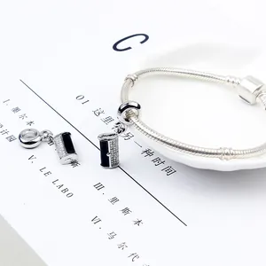 Minimalist snake chain bracelet featuring black enamel and white zircon charms