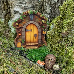 Macro view of a fairy tree door miniature with orange panels and mushroom details