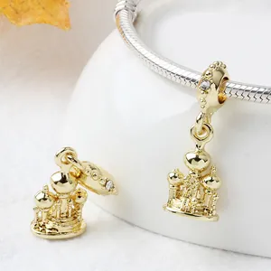 Exquisite gold castle palace charm with zircon detail on a silver snake chain bracelet