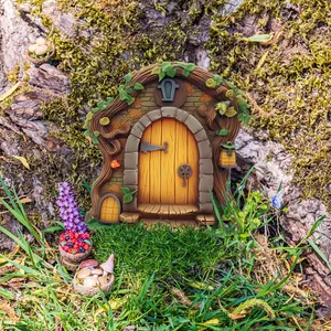 Detail of miniature fairy garden door with resin wood texture and magical vine accents