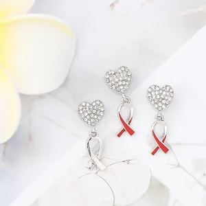 Sparkling diamond-encrusted heart and cross pendant set with red enamel accents