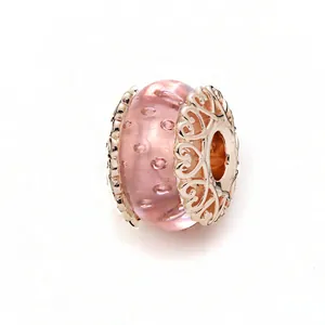 Detail of pink faceted glass charm with rose gold heart hollow metal caps