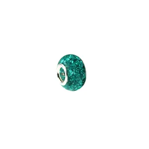 Macro detail of emerald green ice crackle crystal bead with a polished silver metal core