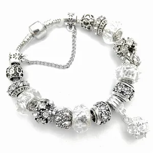 Silver charm bracelet with purple crystal beads, snowflake charms and safety chain