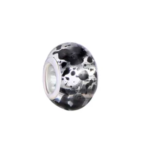 Macro detail of DIY charm bead with black and white ink pattern and silver metal core