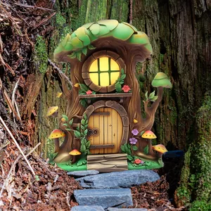 Macro detail of fairy tree house resin garden decor with glowing window on tree trunk