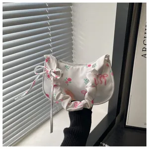 Detail of floral armpit bag with pink rose patterns and pleated handle design