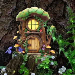 Detailed view of miniature garden tree house with glowing windows and mushroom roof