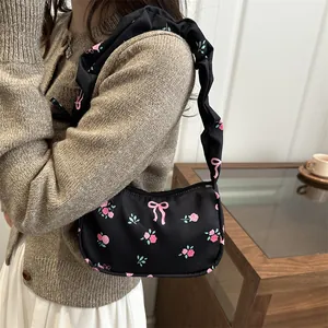Black floral shoulder bag with pink rose patterns and pleated strap for casual wear