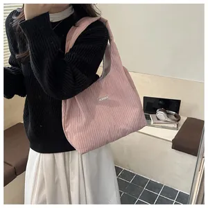 Detailed texture of pink pleated knit tote bag with minimalist fashion label detail