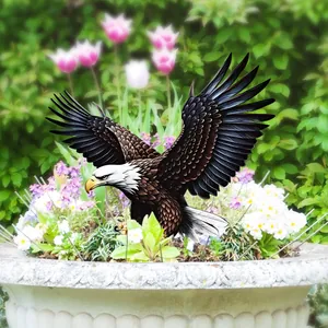 Detailed garden stake of a realistic eagle landing in a flower pot with lush blooming flowers