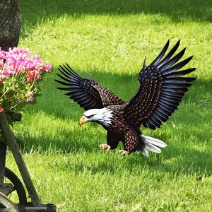Detailed garden stake featuring a realistic diving bald eagle statue on a lush lawn