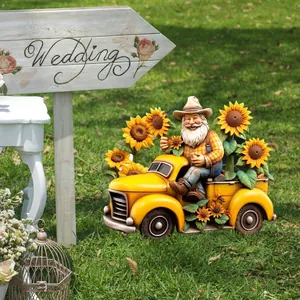 Garden gnome driving yellow truck ornament with sunflowers on lawn display