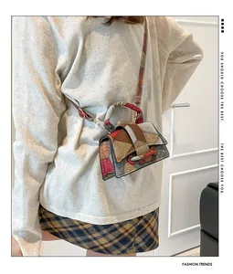 Detailed view of a retro patchwork crossbody bag with colorful leather panels and strap