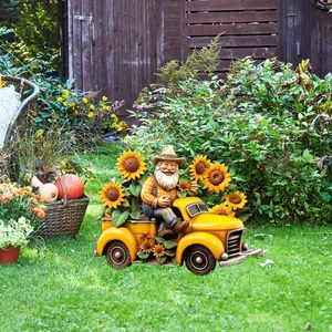 Outdoor garden gnome driving a yellow vintage truck with sunflowers on green grass