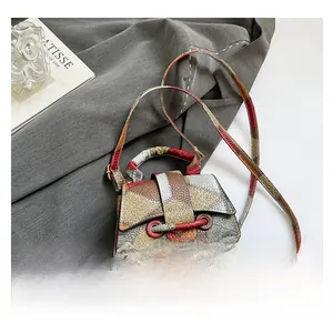 Macro view of multi-color patchwork crocodile pattern leather on the square shoulder bag