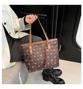 Detail of large brown tote bag set with diamond pattern and matching small pouch