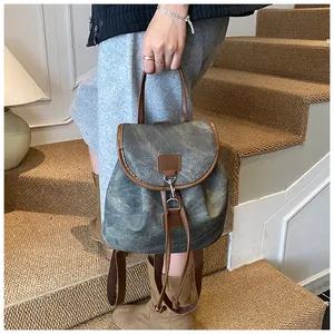 Close-up of contrast color backpack with flap hook closure and drawstring details