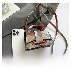 Mini color-blocked crossbody bag with textured leather shown next to a smartphone