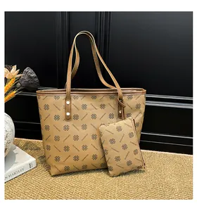 Khaki tote bag with matching pouch featuring clover prints and thin brown handles