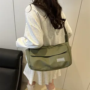 Army green large nylon crossbody bag with fashion label and wide shoulder strap
