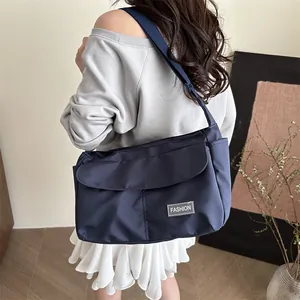 Large dark blue waterproof nylon crossbody bag with adjustable strap for travel use