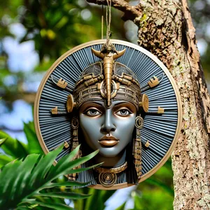 Detailed close-up of Ancient Egyptian goddess resin plaque on a tree branch