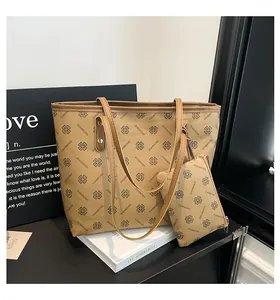 Detail view of khaki large capacity tote bag with matching zipper pouch and clover prints
