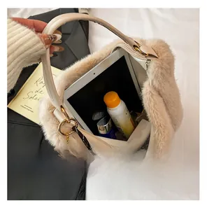 Interior view of large beige plush tote bag showing storage for tablet and cosmetics